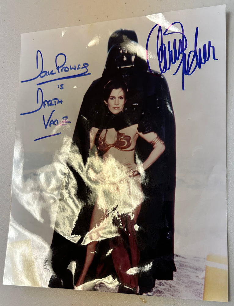
                  
                    Carrie Fisher as Princess Leia & Dave Prowse as Darth Vader in Star Wars: Return of the Jedi Signed Rolling Stone Beach Shot 8x10 Photo
                  
                