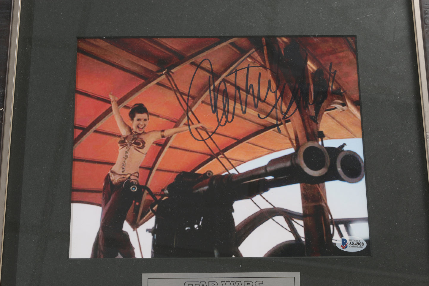 
                  
                    Carrie Fisher as Slave Princess Leia in Star Wars: Return of the Jedi (Beckett) Signed 8x10 Photo Framed with a Plaque
                  
                