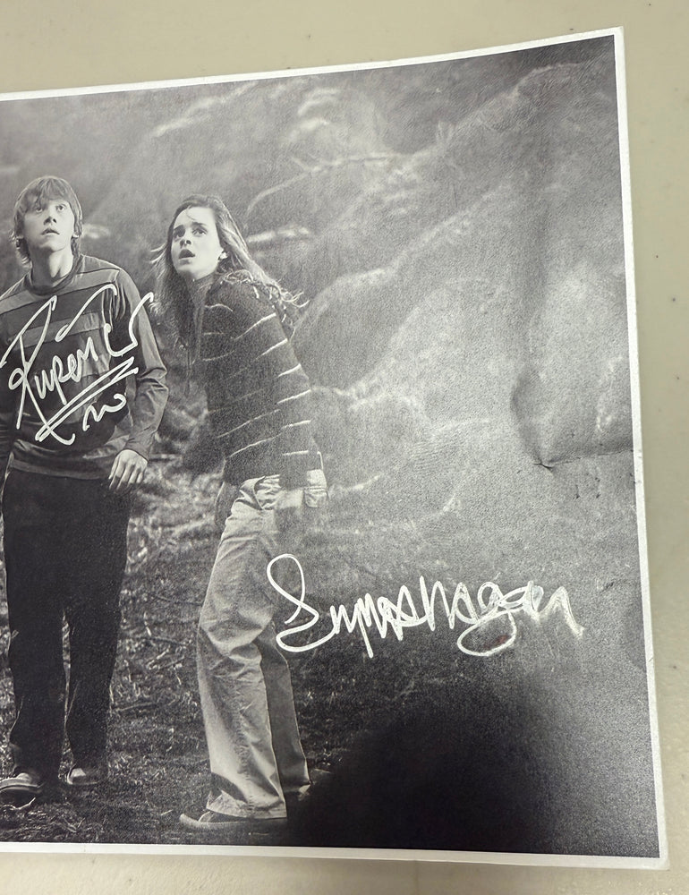 
                  
                    Daniel Radcliffe as Harry Potter, Emma Watson as Hermione Granger, & Rupert Grint as Ron Weasley in Harry Potter and the Order of the Phoenix Signed 5.5x8 Photo
                  
                