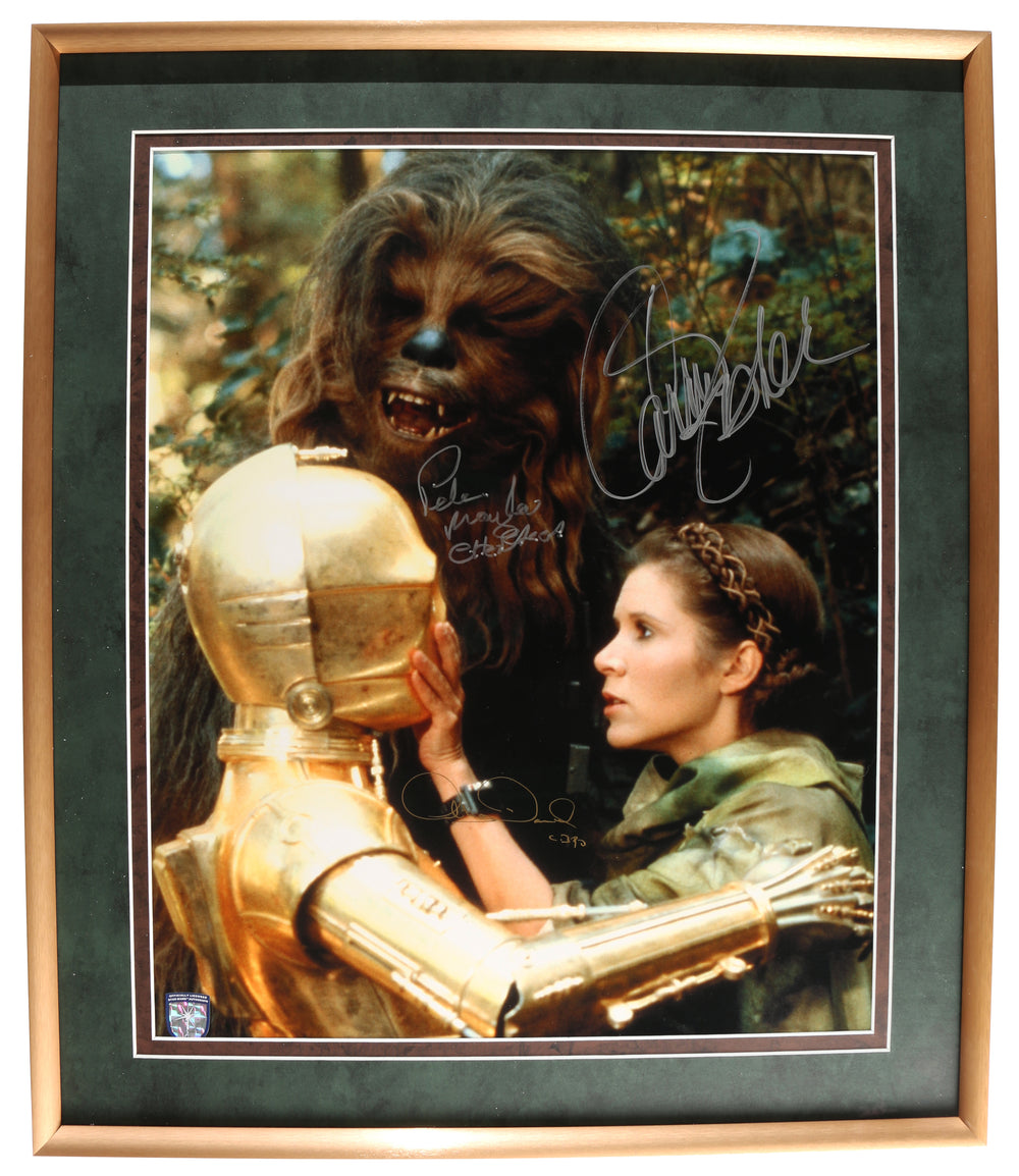 Carrie Fisher as Princess Leia, Peter Mayhew as Chewbacca, & Anthony Daniels as C-3PO in Star Wars: Return of the Jedi (Official Pix Lightsaber Shield) Framed Signed 16x20 Photo